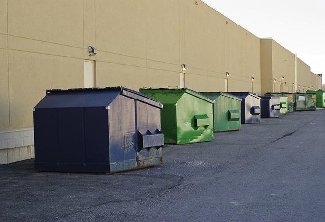 a row of heavy-duty dumpsters ready for use at a construction project in Iselin